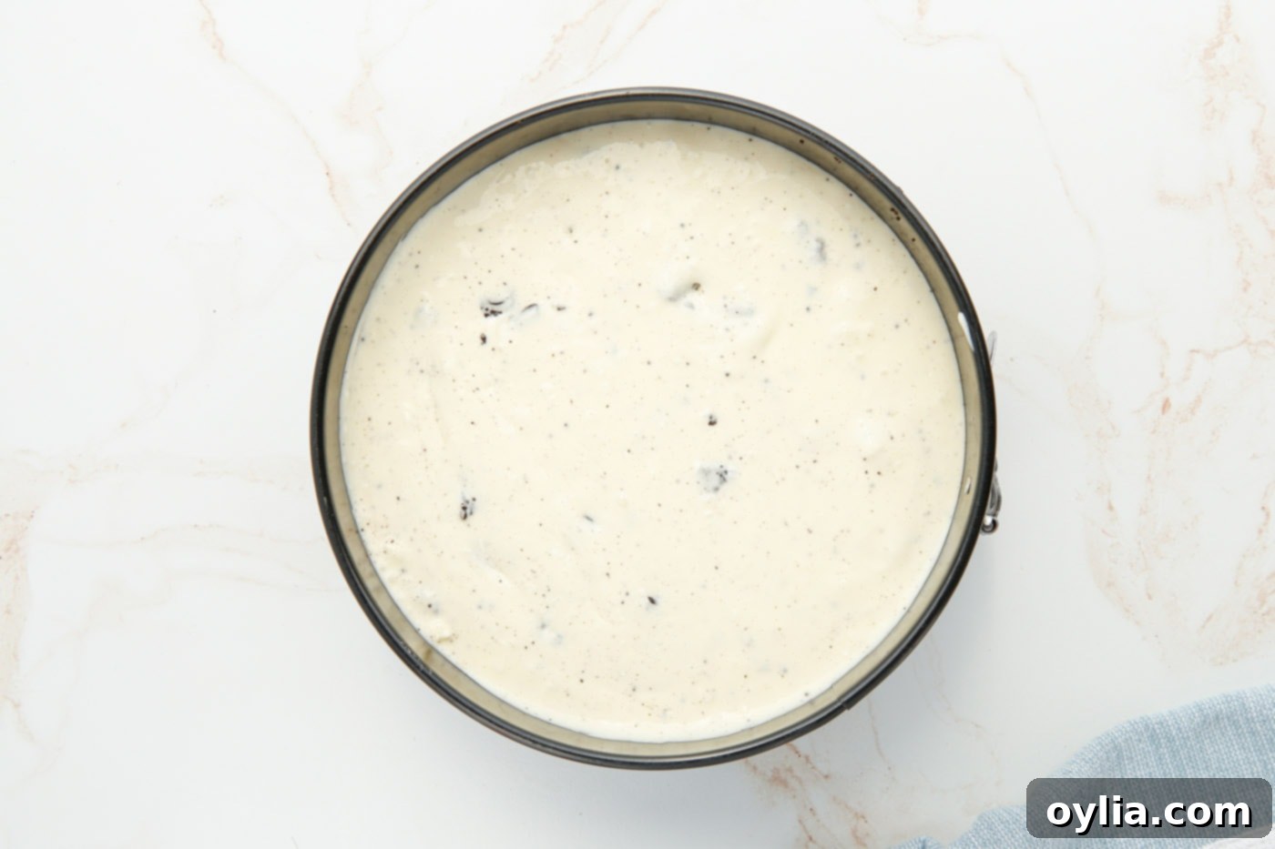 Oreo cheesecake batter poured into a springform pan, ready for the Instant Pot