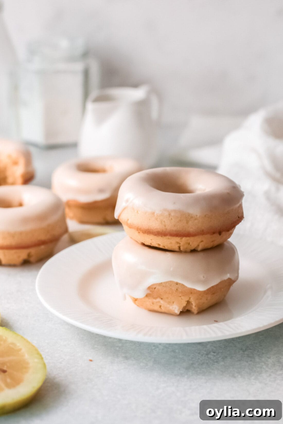 Lemon Baked Donuts on a plate, showing their soft texture and lemon glaze