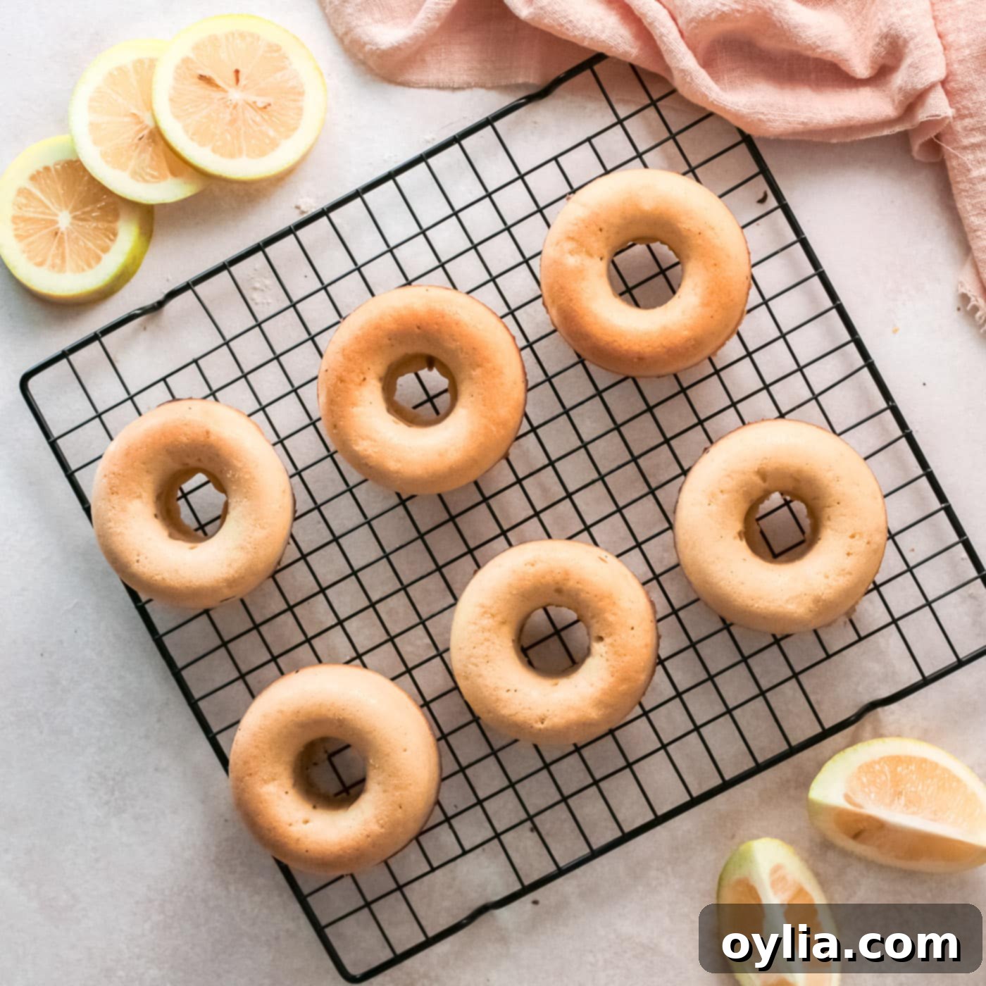 baked lemon donuts cooling on a wire rack