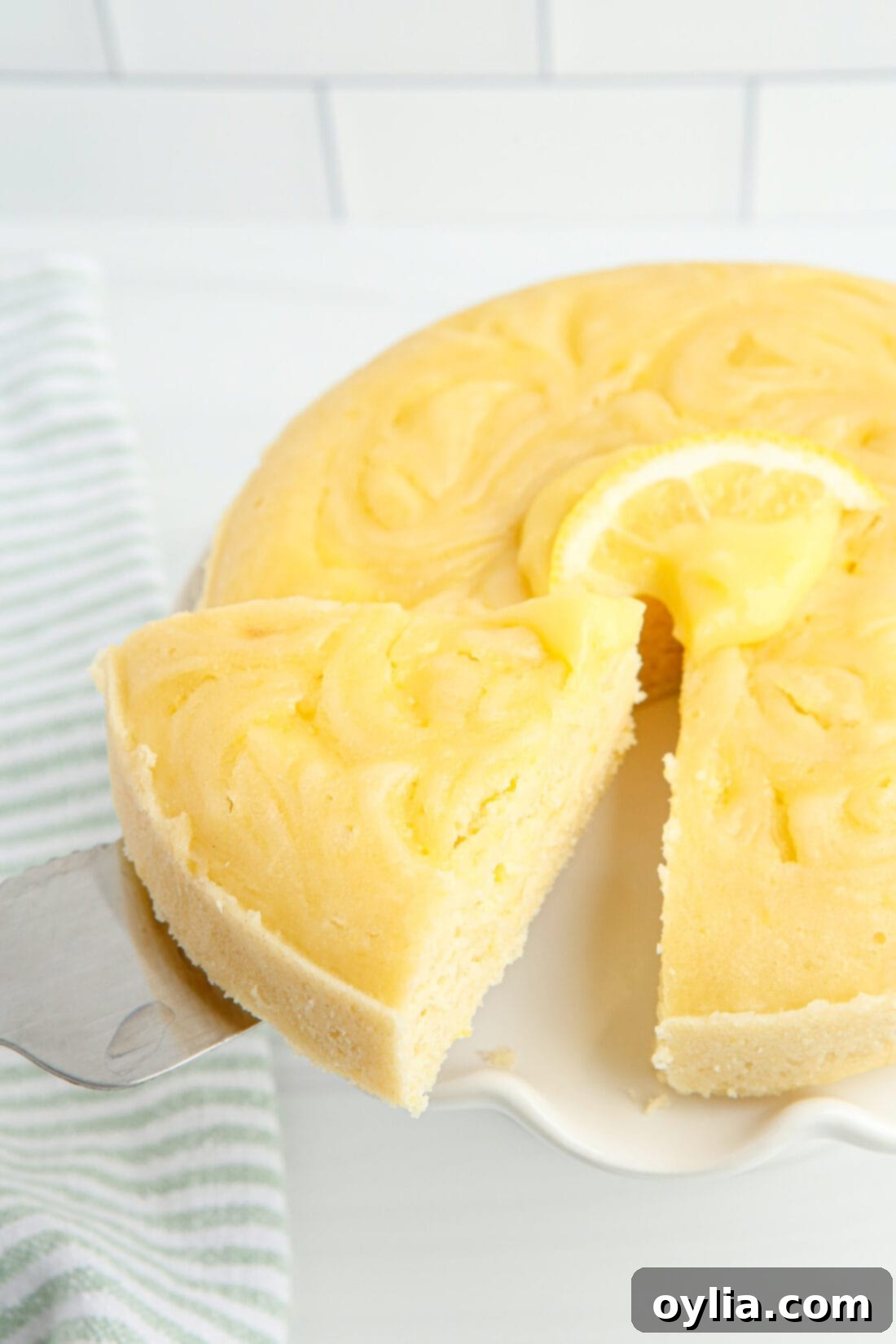 removing a slice of Instant Pot Lemon Cake