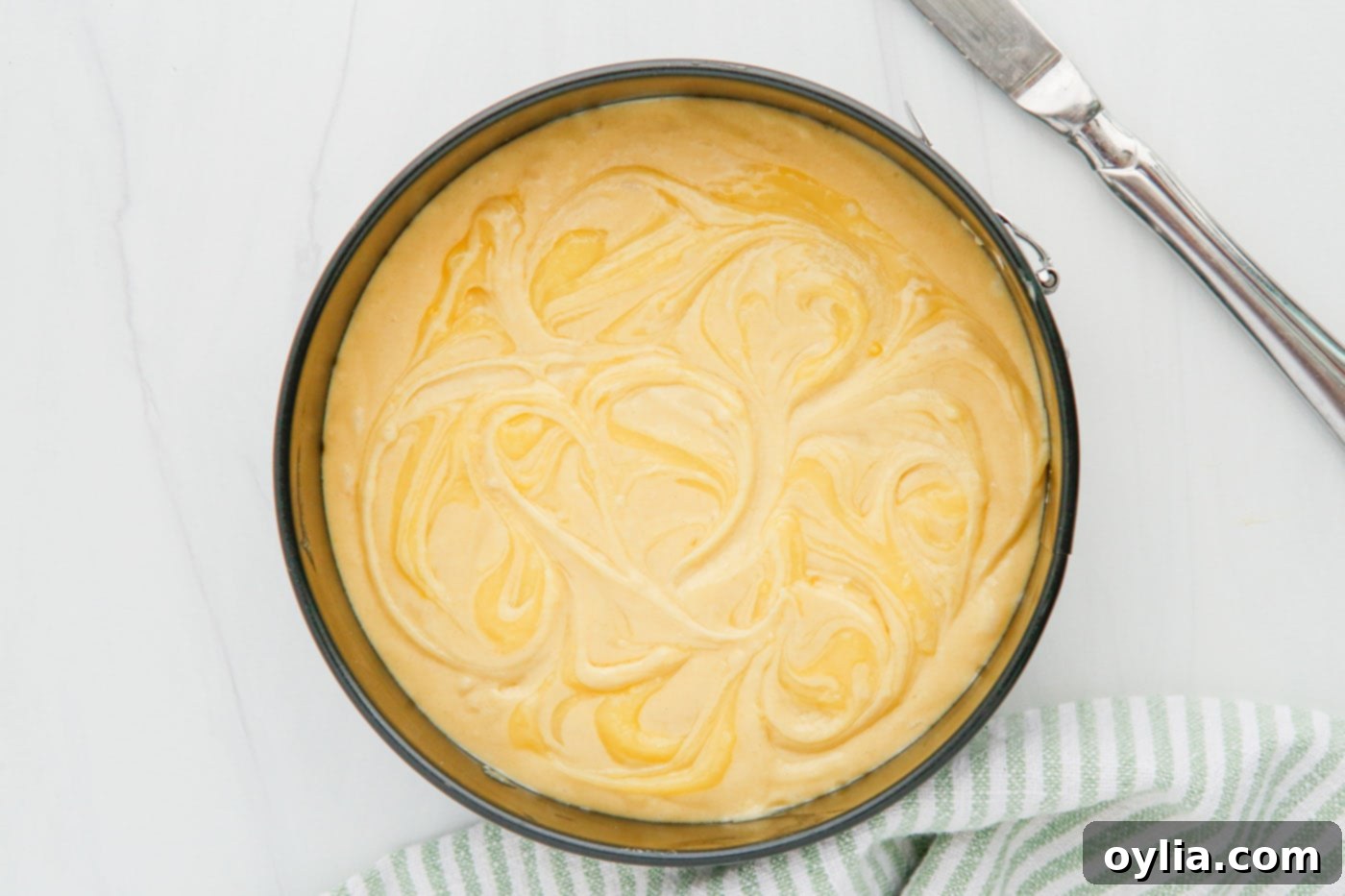 swirled lemon curd on top of cake batter