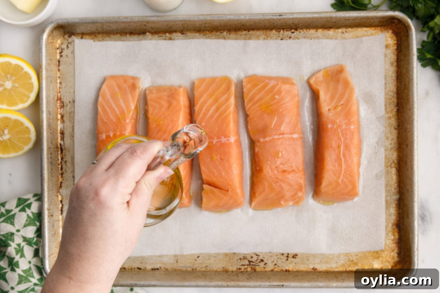 drizzling oil over salmon filets