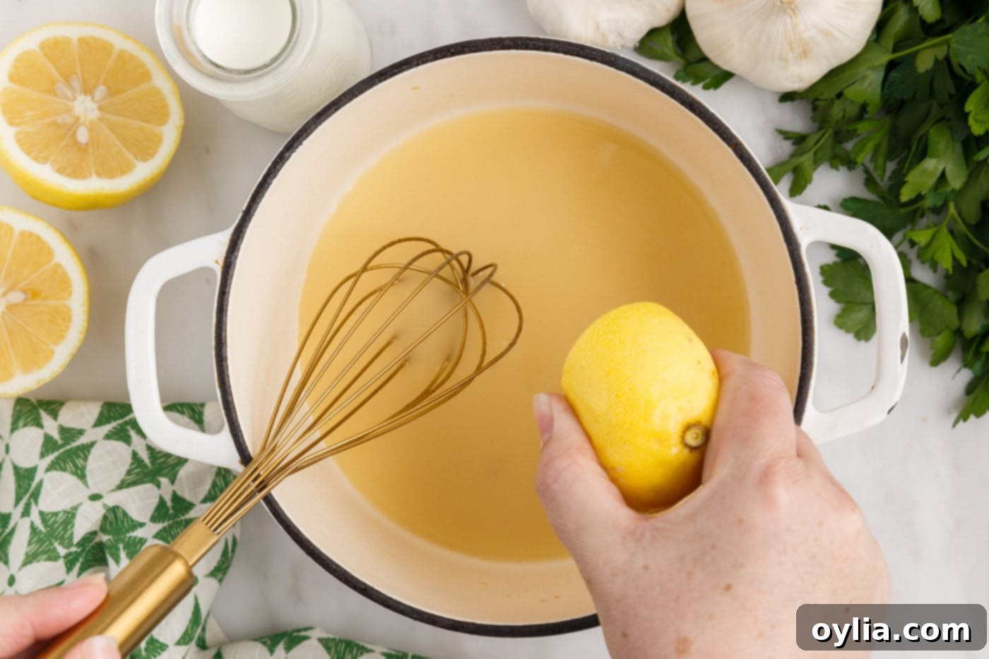 squeezing lemon juice into cream sauce