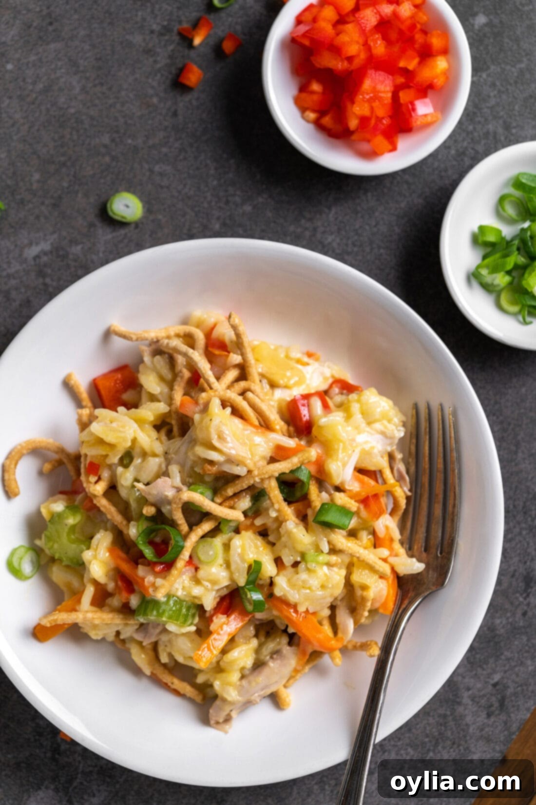 A serving of Chicken Chow Mein Casserole on a white plate, showcasing its creamy texture and crispy noodles.
