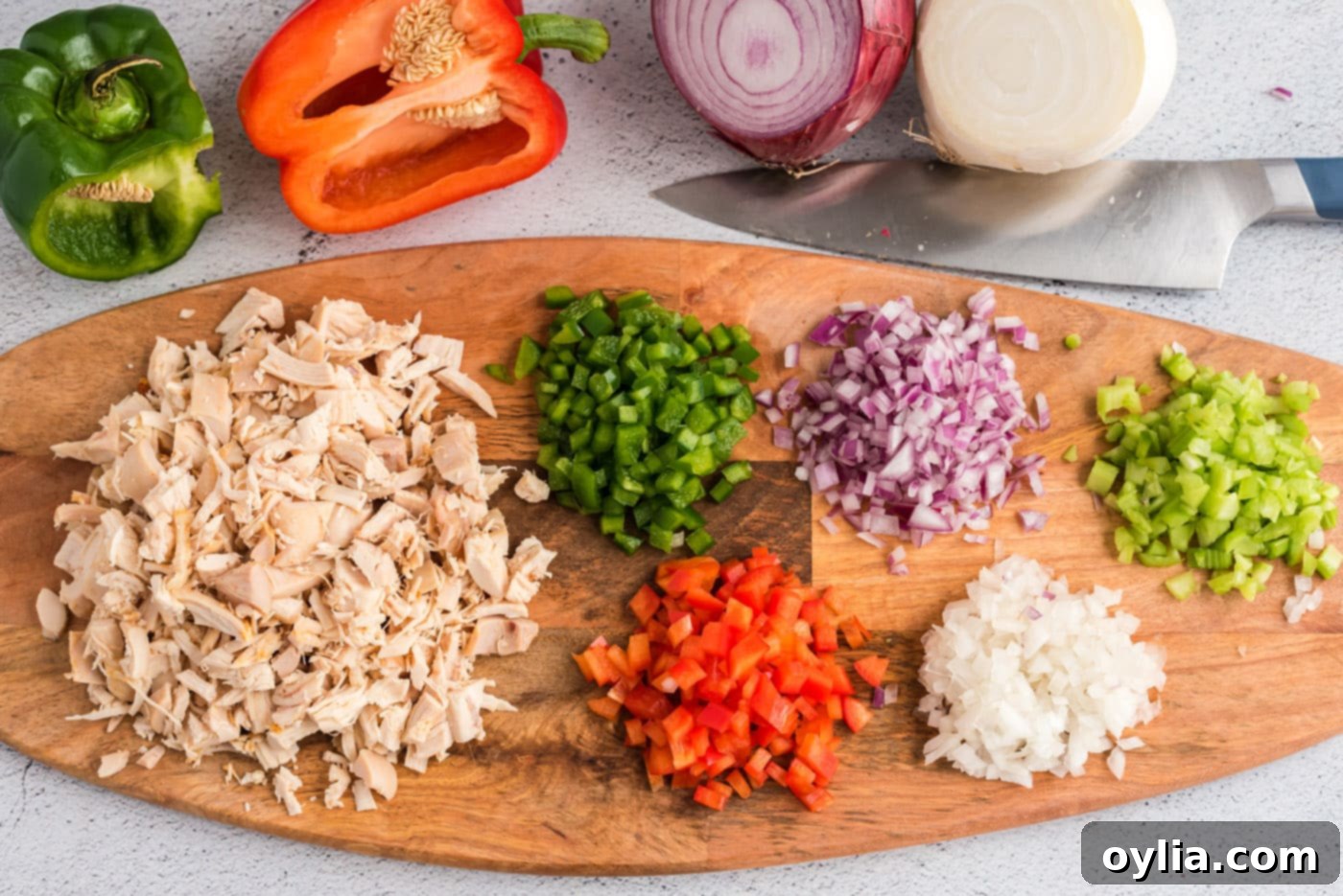 chopped veggies and chicken on a cutting board