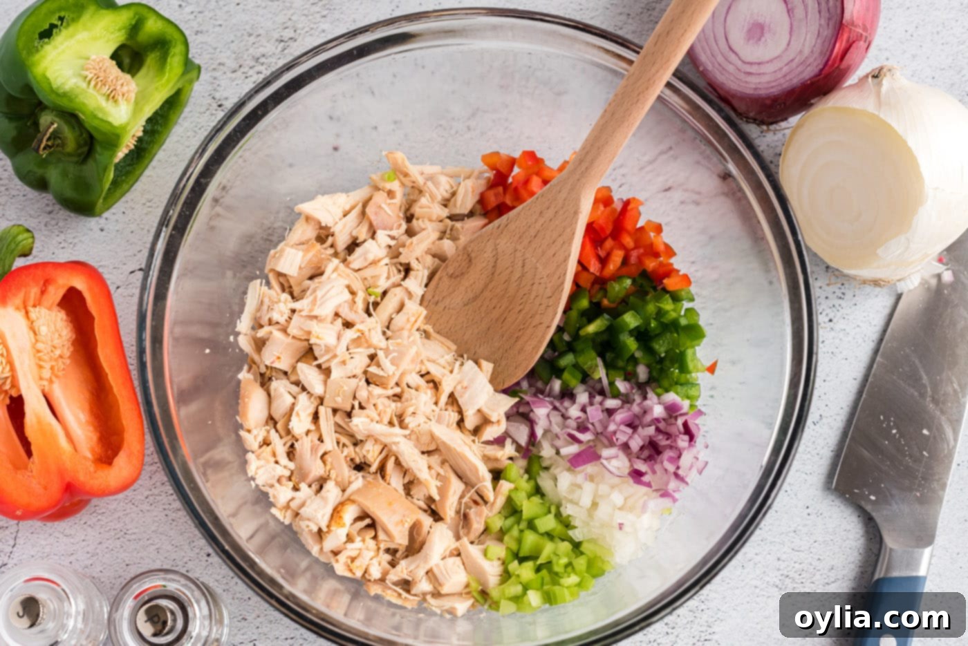 chicken, celery, green and red bell pepper, ,and onion in a mixing bowl