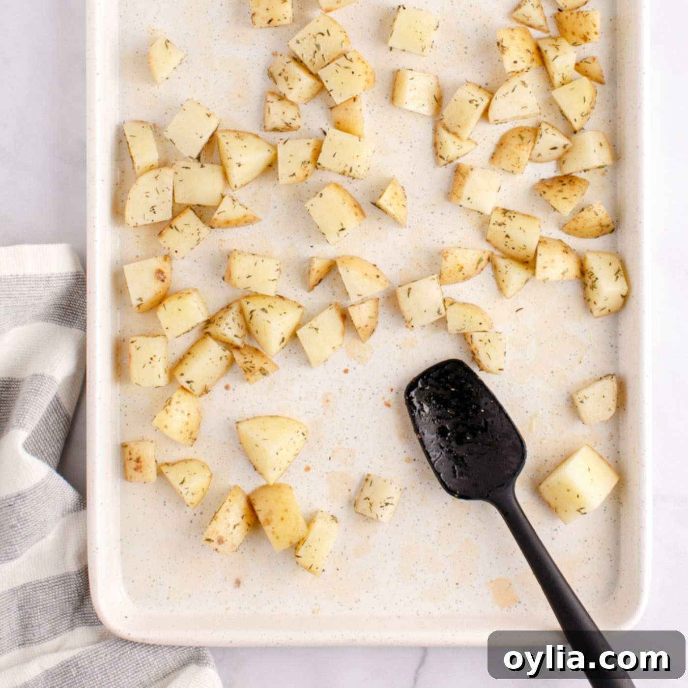 cubed potatoes on a baking sheet