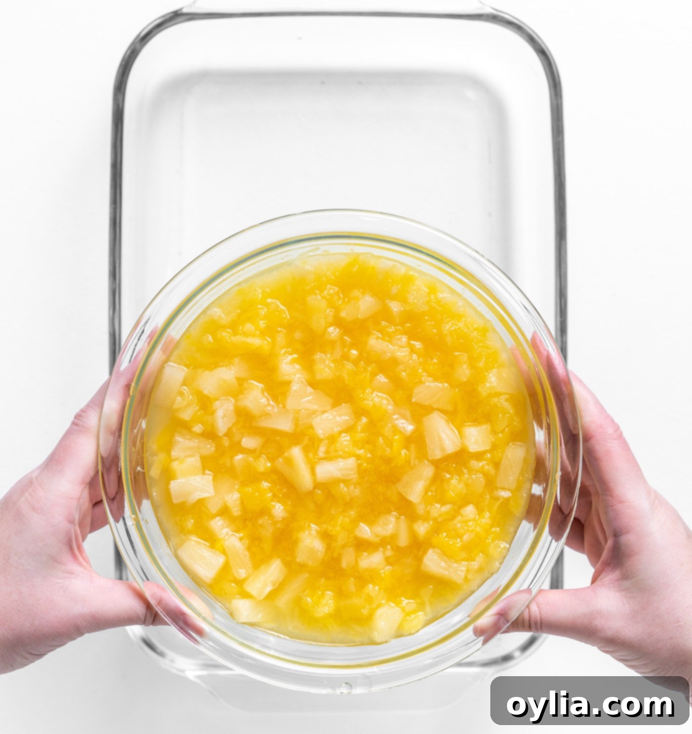 crushed pineapple with juice spread evenly in a baking dish