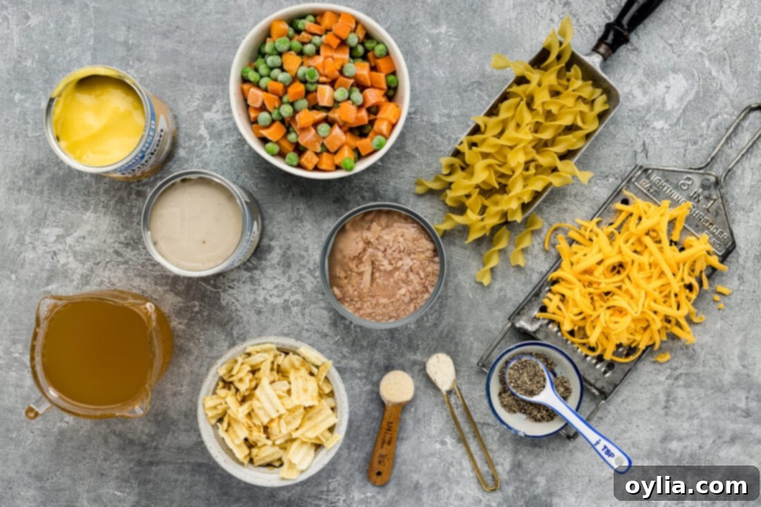 Collection of fresh ingredients for Tuna Casserole, including canned tuna, egg noodles, cheese, and vegetables