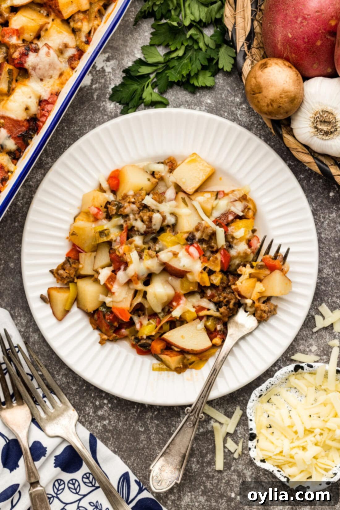 Hearty Sausage and Spud Bake 2 Plate of Sausage and Potato Casserole with a fork on the side