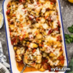 Hearty Sausage and Spud Bake 12 Sausage and Potato Casserole with a spoon in it