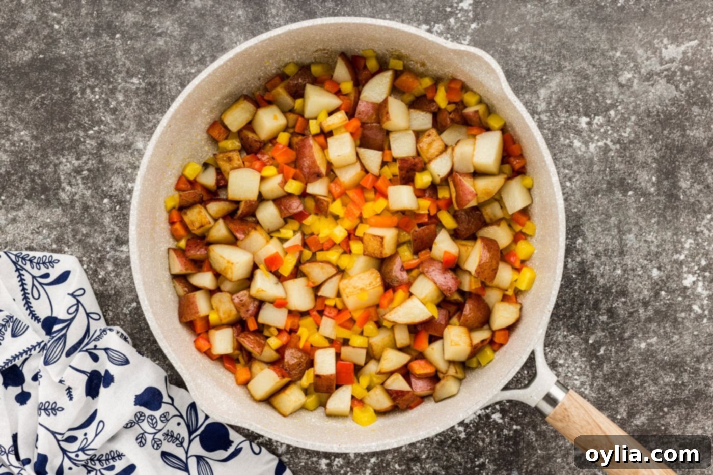 sausage with peppers and potatoes in a skillet