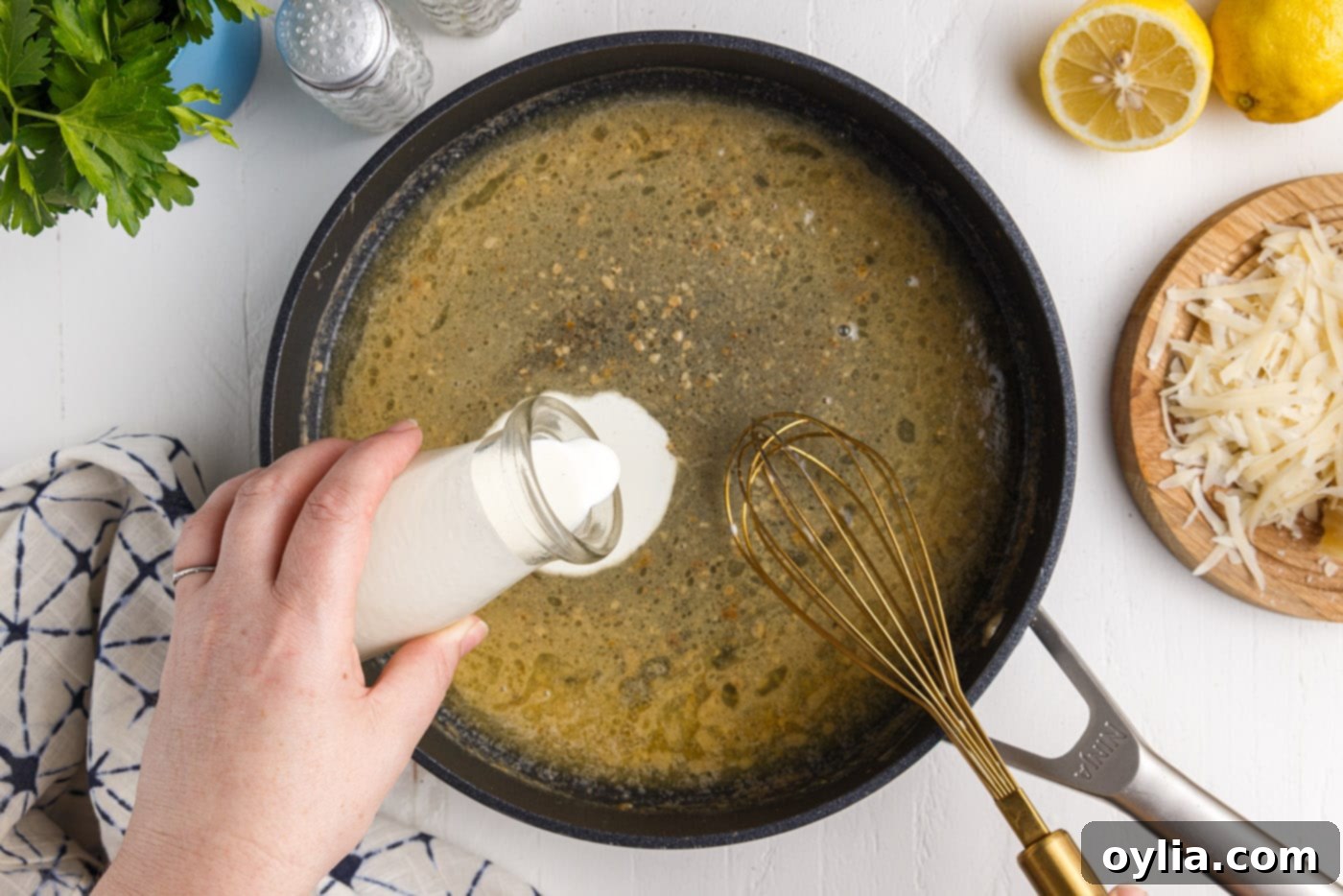 adding milk to a skillet of butter and lemon juice