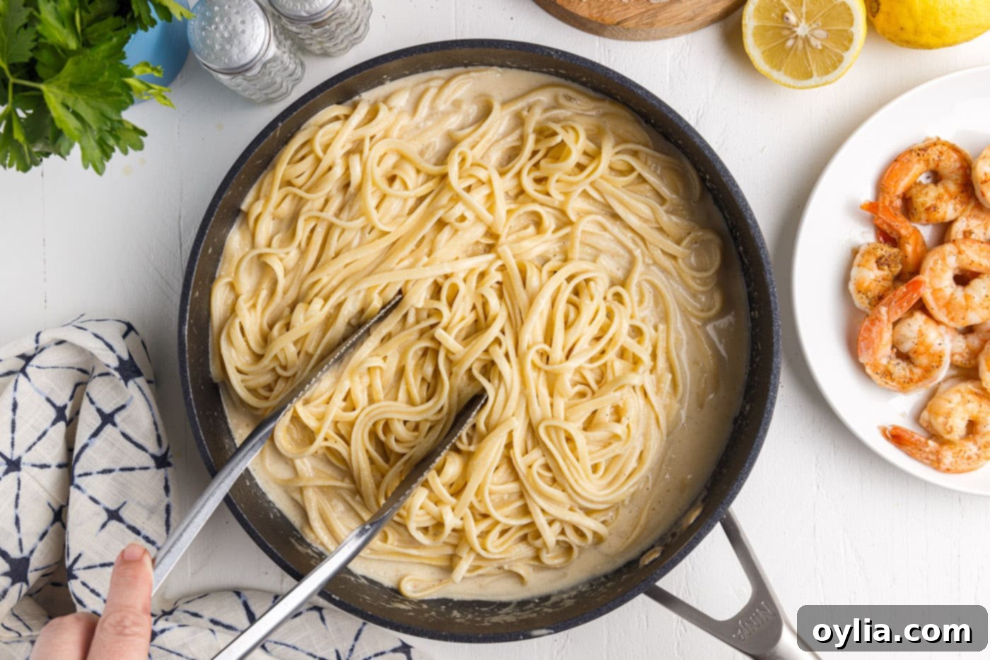 tossing noodles in lemon garlic sauce