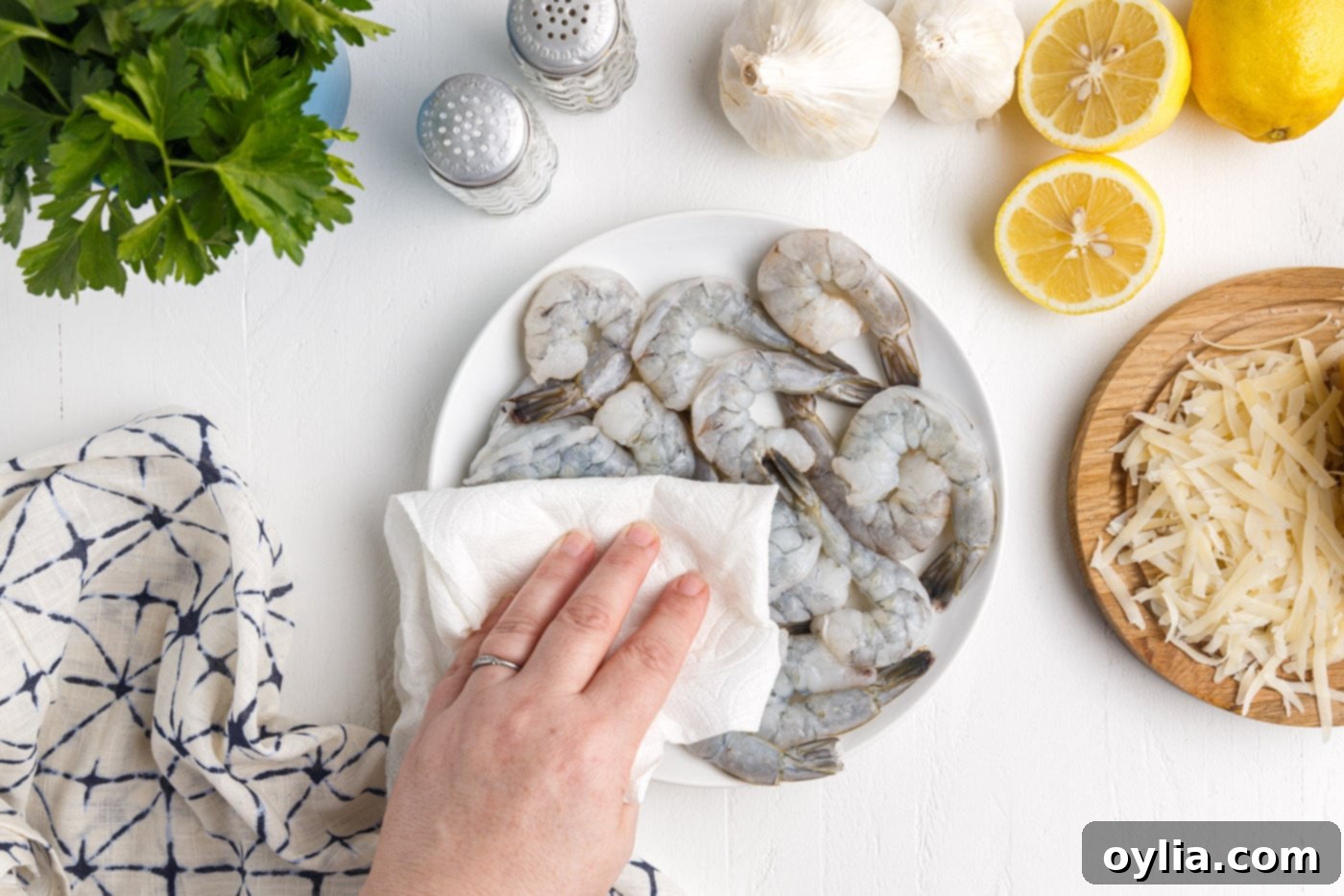 patting shrimp dry with a paper towel