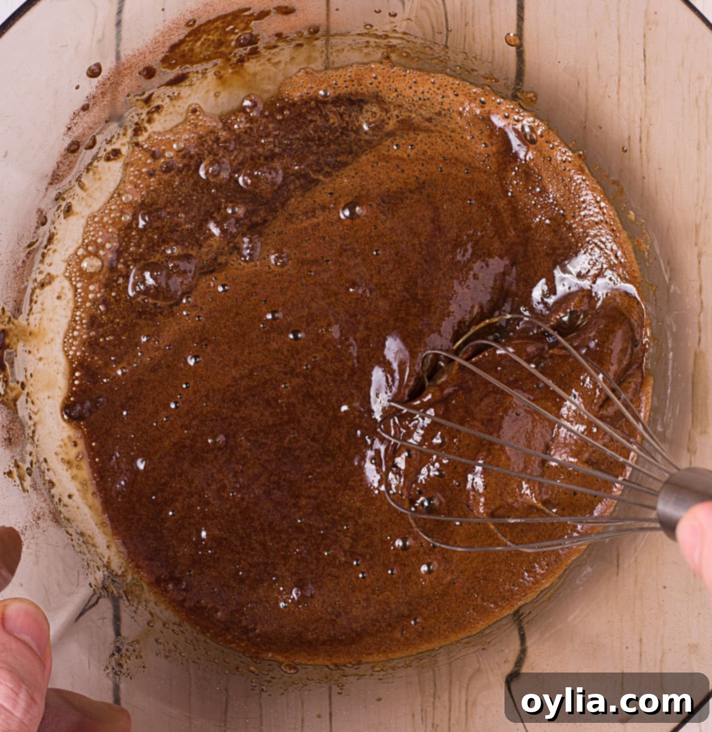 whisking instant coffee, water, and sugar in a bowl