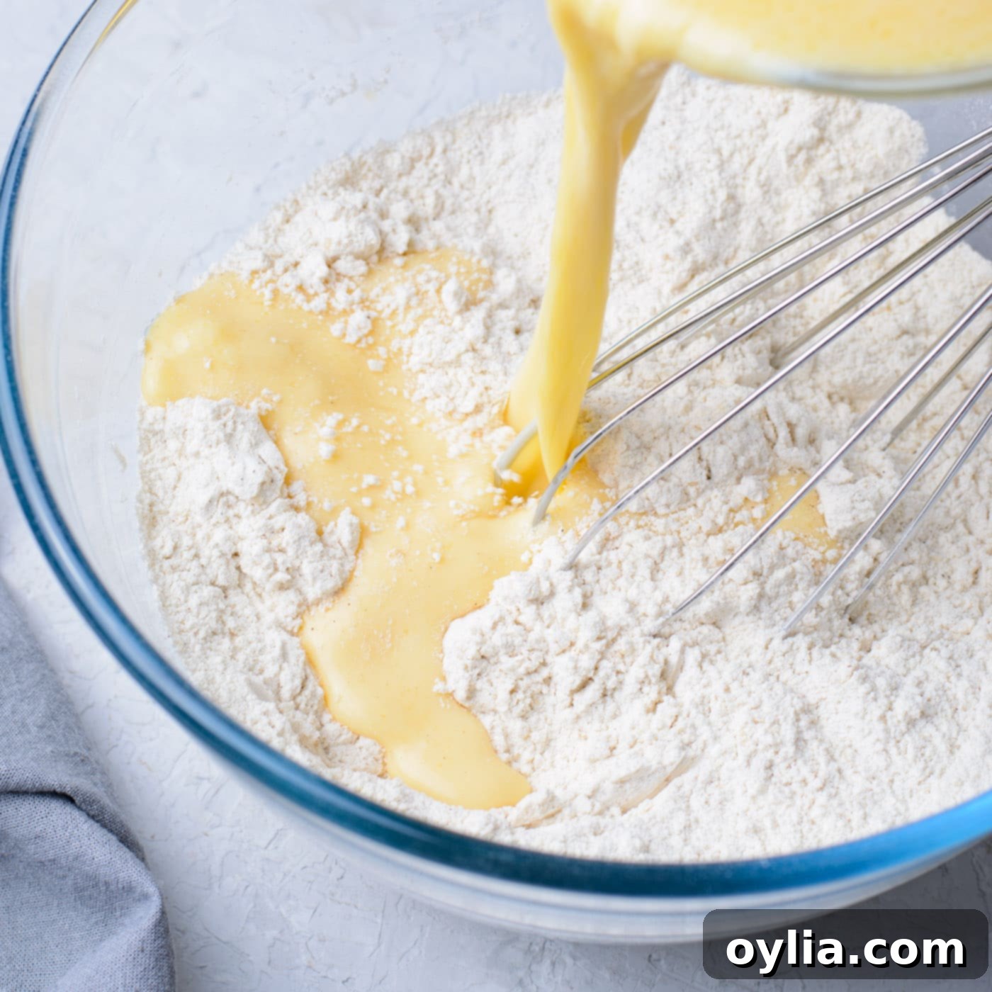pouring batter into dry ingredients for banana fritters