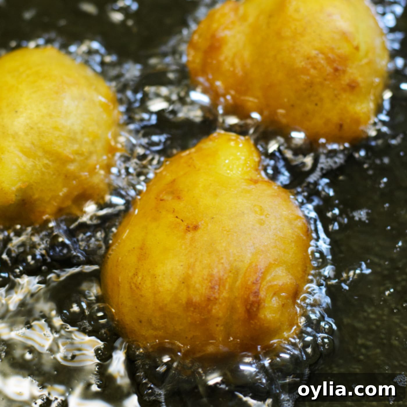 frying banana fritters in a pan