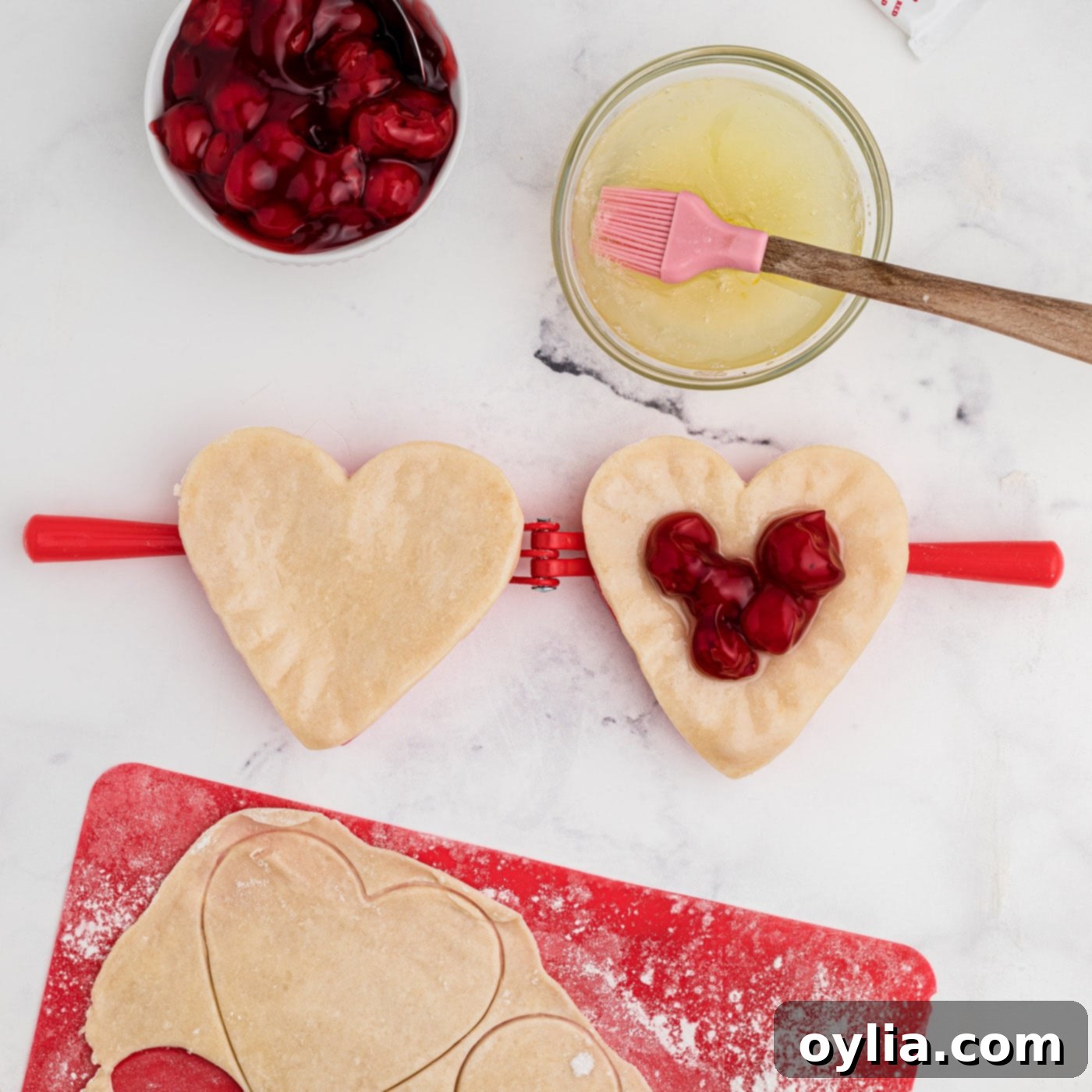 cherry pie filling inside heart shaped pie dough