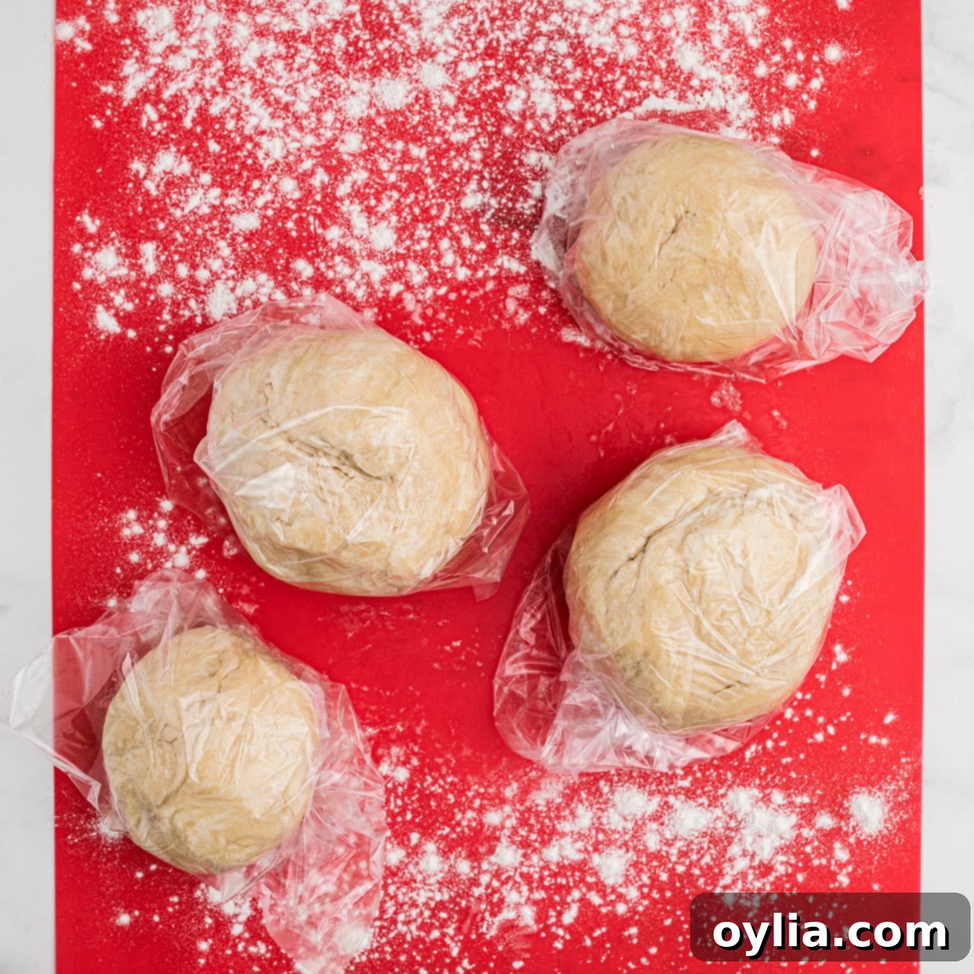 small pie dough balls on floured surface