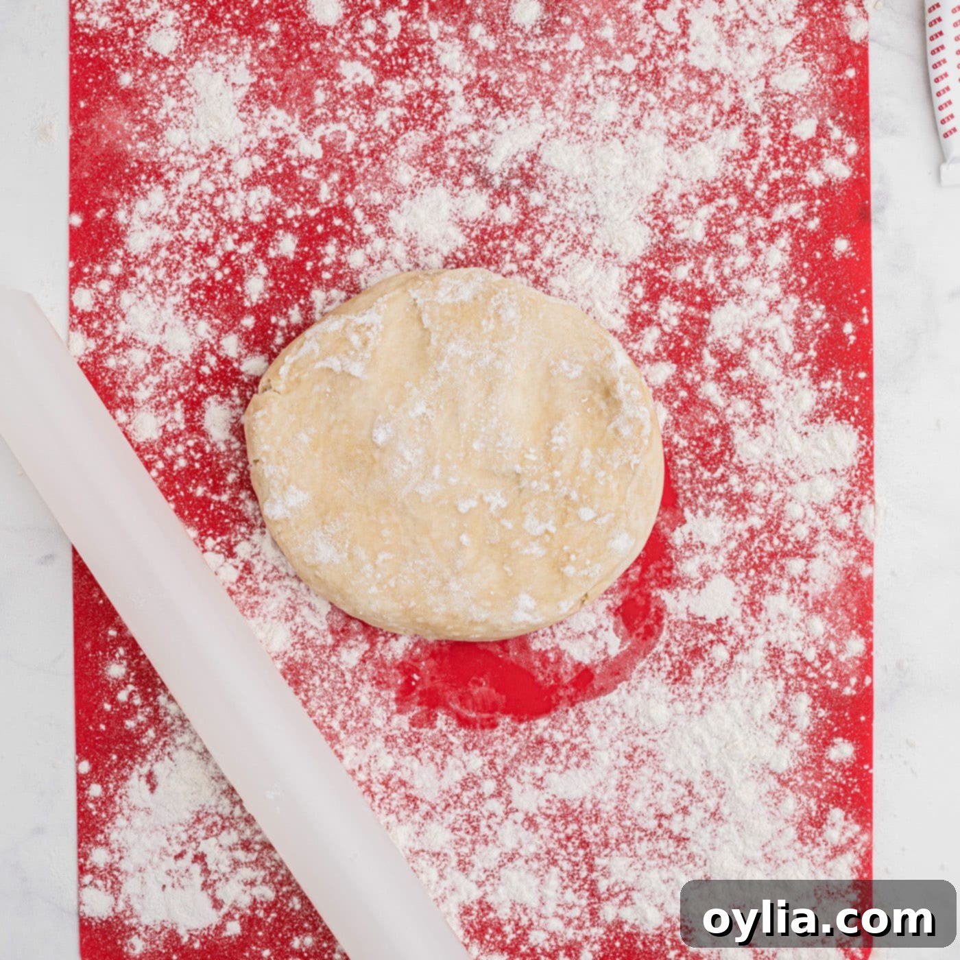rolling out pie dough with flour