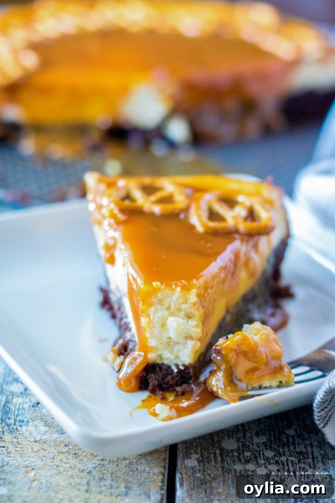slice of Salted Caramel Cheesecake with bite out of it
