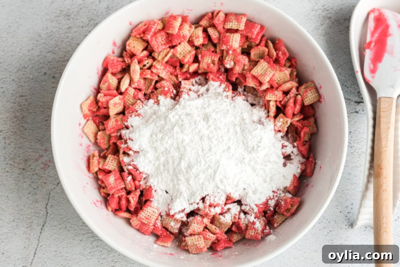 powdered sugar over chocolate coated chex cereal