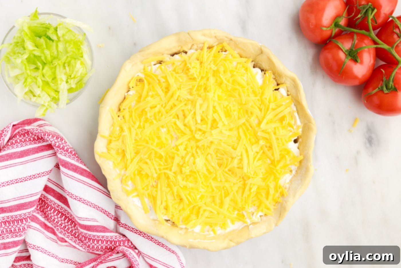 a layer of shredded cheese generously topping the taco pie before baking