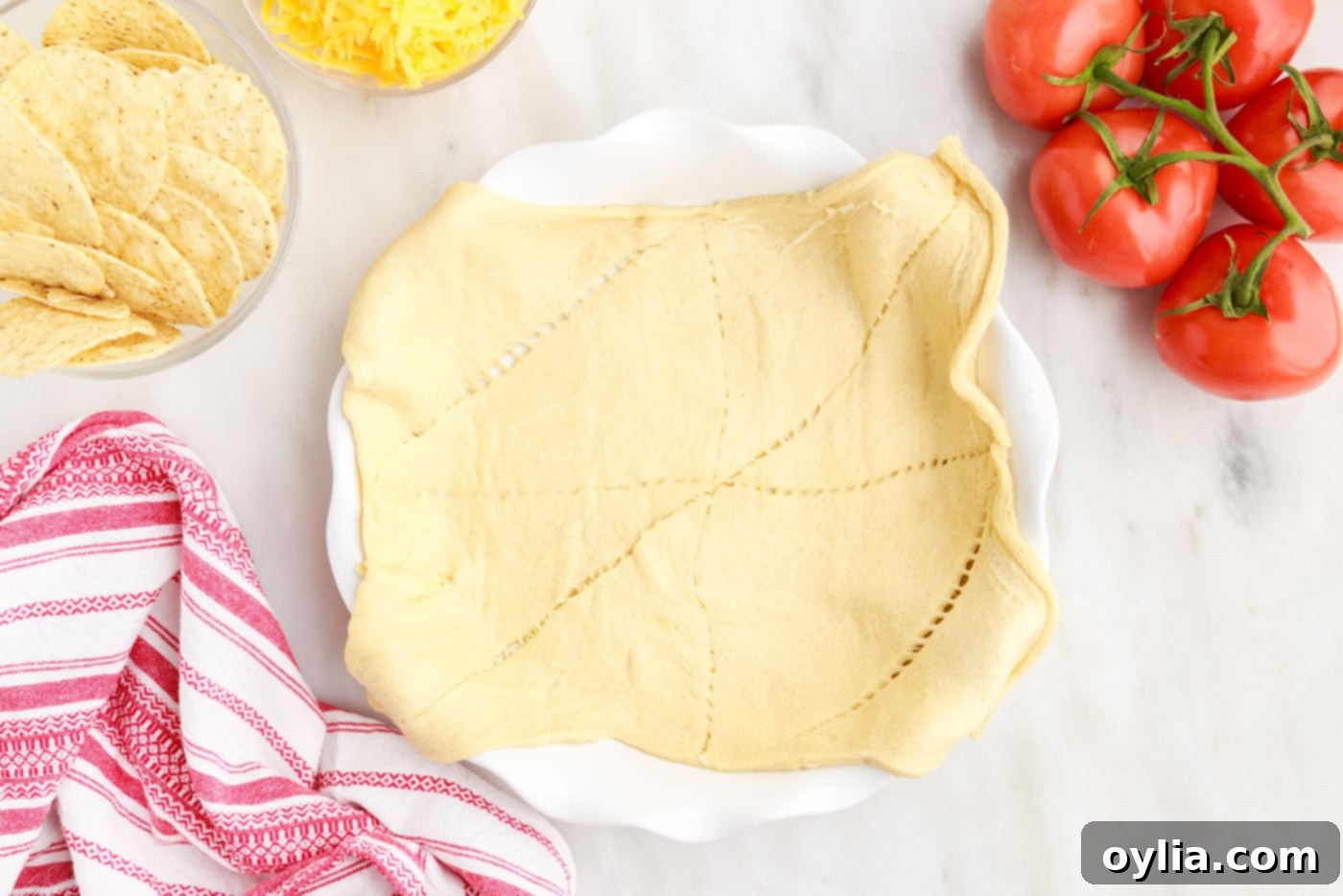 crescent rolls laid out and pressed into a pie plate, forming the crust
