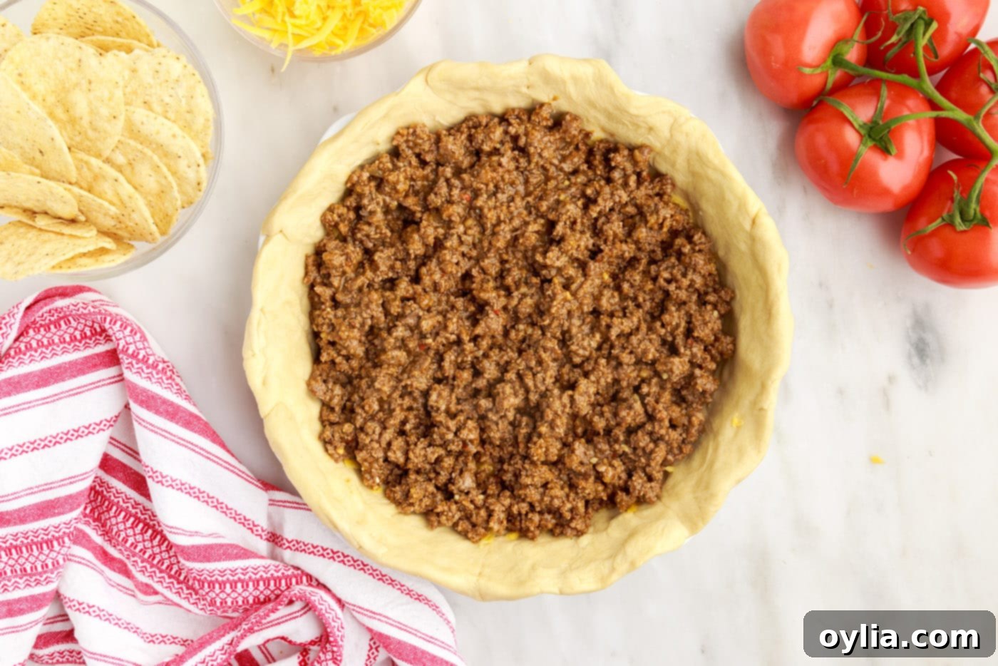 seasoned ground beef spread over the cheese layer on the crescent roll crust