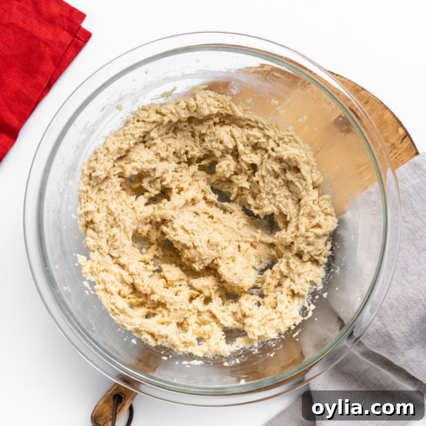 Creamed butter, granulated sugar, and brown sugar mixed to a light and fluffy consistency in a bowl