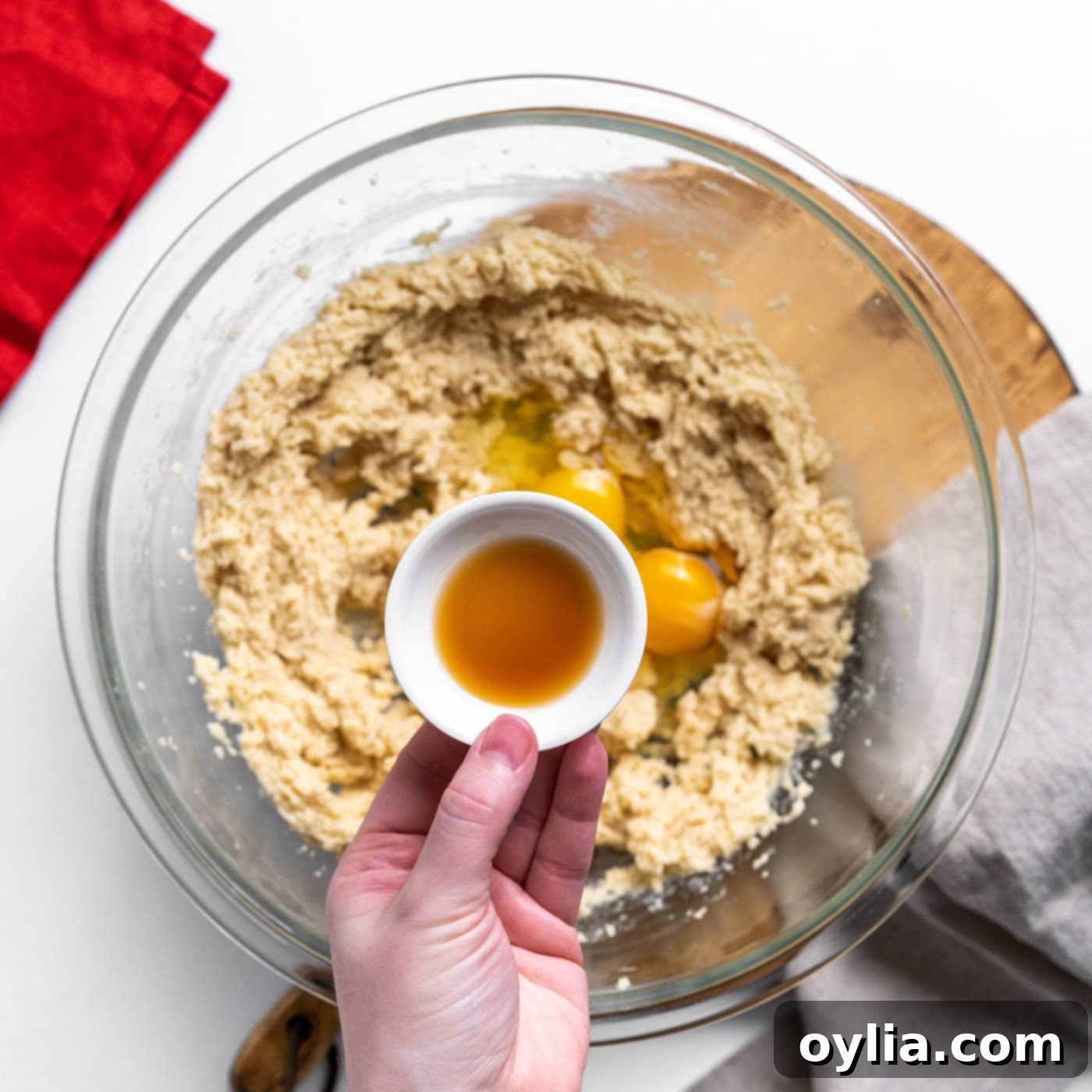 Adding vanilla extract to the cookie mixture during the wet ingredient incorporation phase