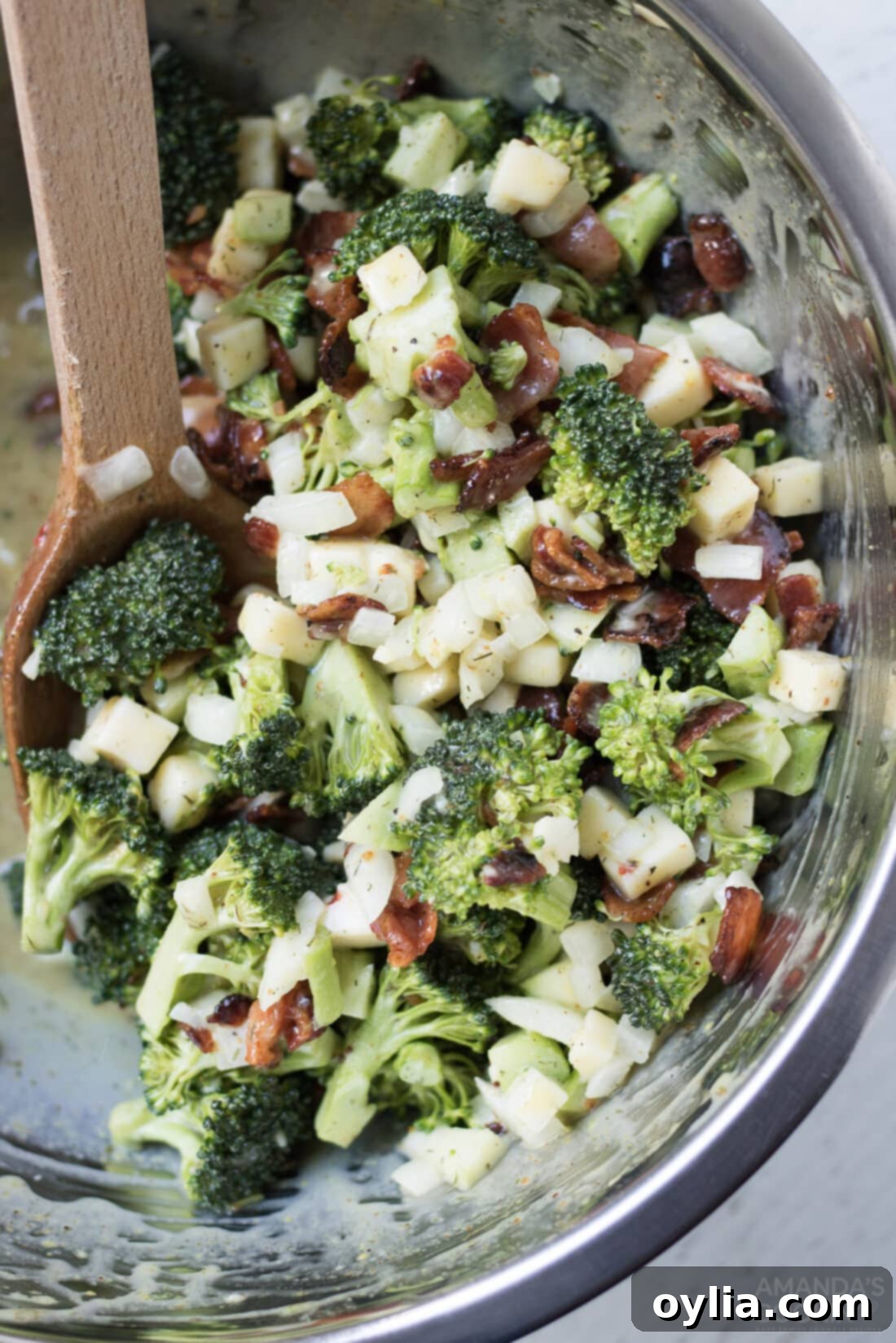 bowl of classic broccoli salad with bacon, cheese, and onion