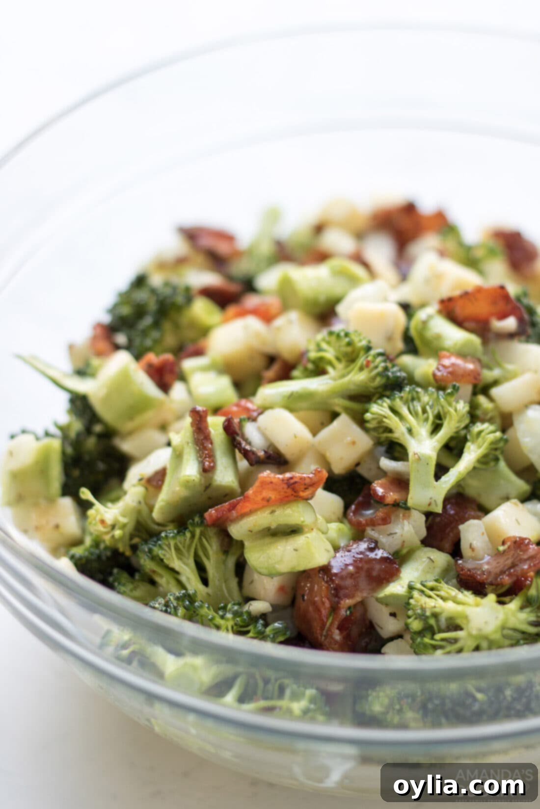 close-up of classic broccoli salad ingredients mixed in a large bowl