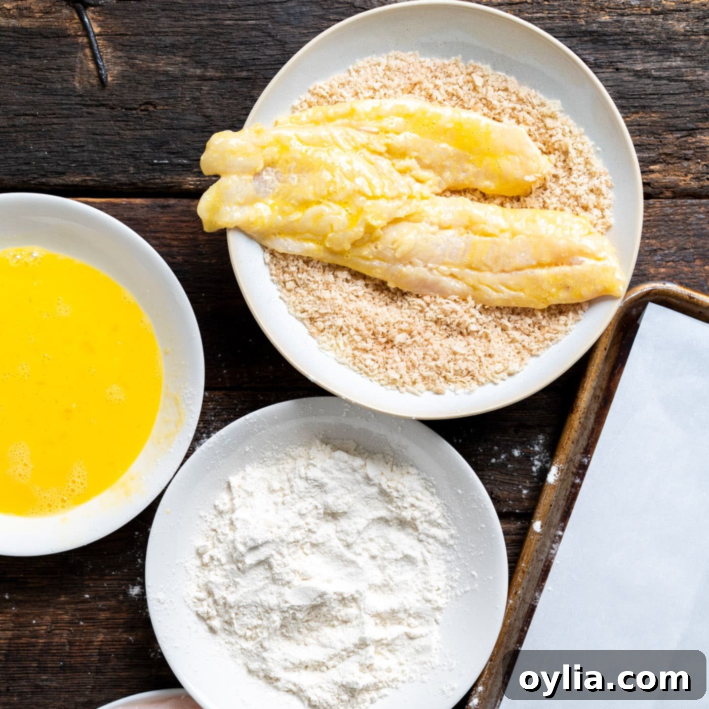 dipping cod fillets into panko breadcrumbs