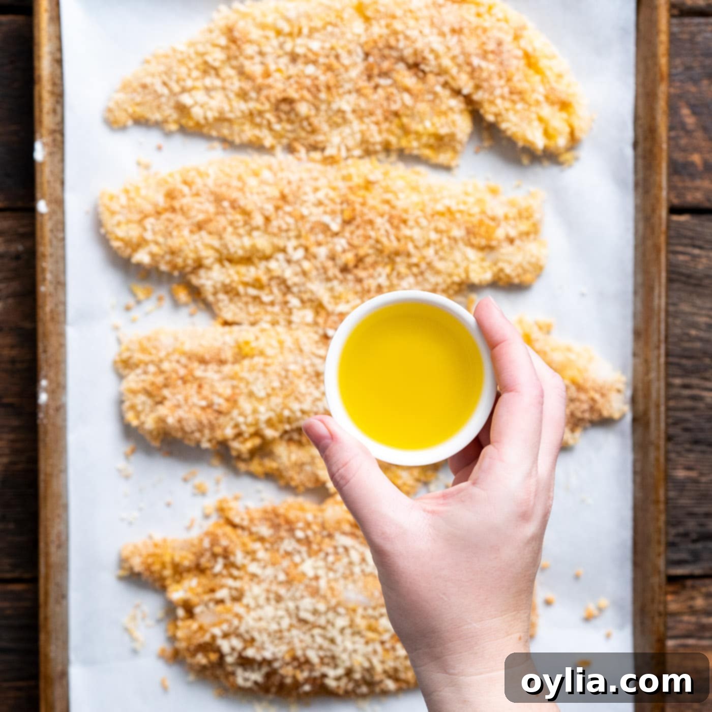 drizzling olive oil over fish fillets