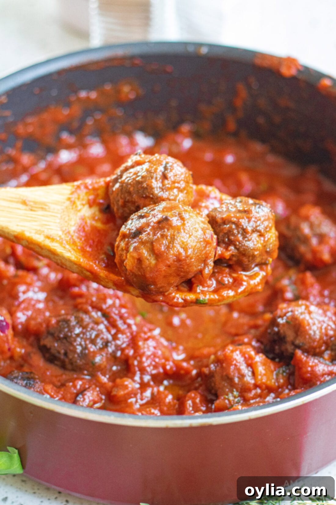 Classic Spaghetti and Meatballs 3 lifting meatballs from marinara