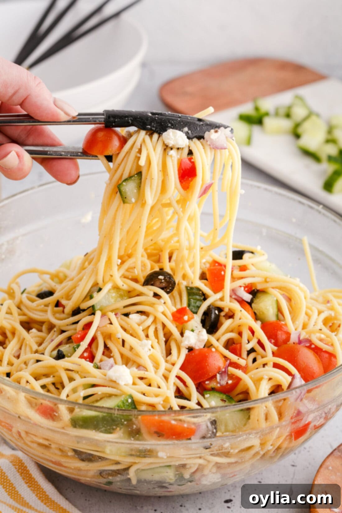 Spaghetti Salad lifted by tongs