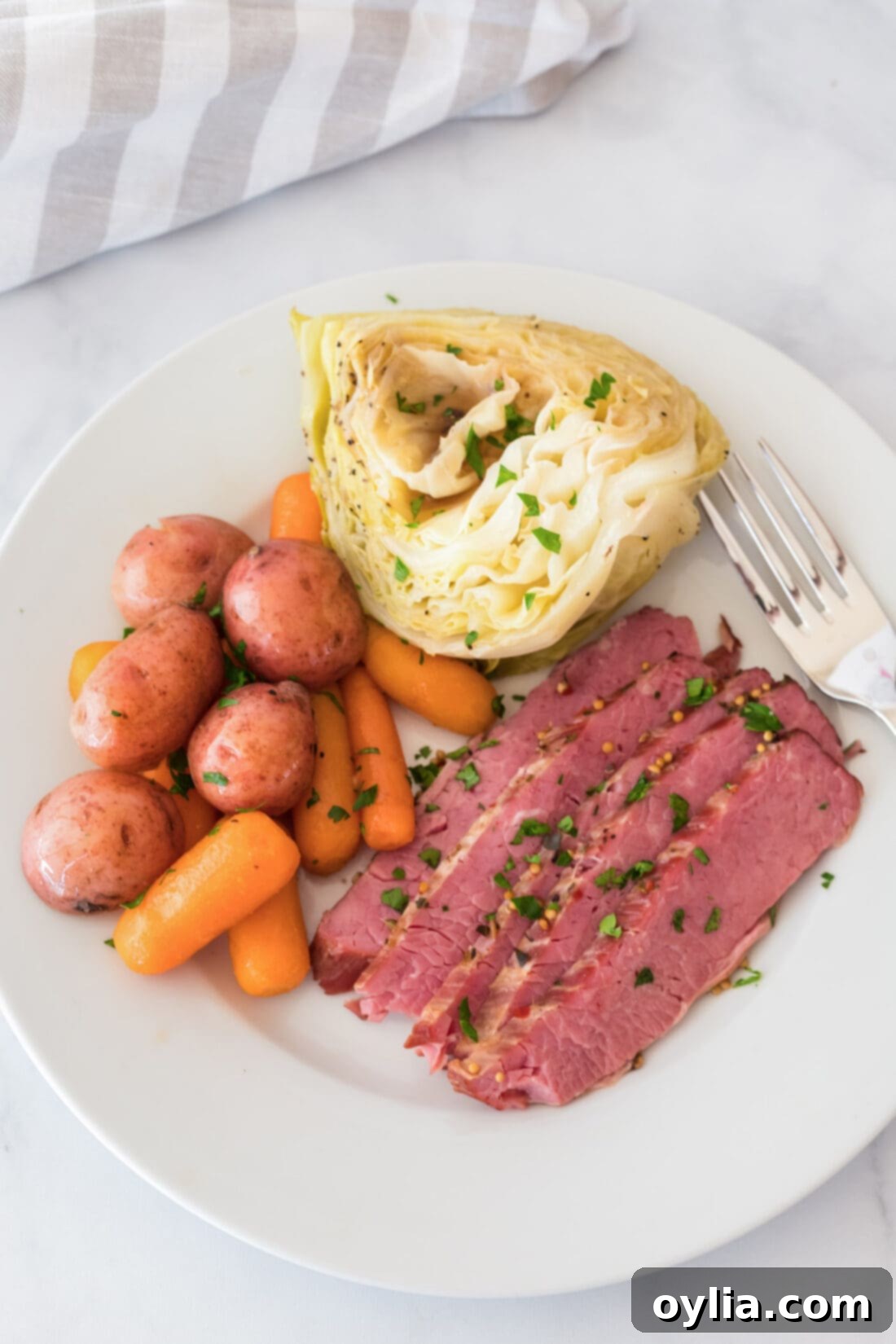 Instant Pot Corned Beef on a plate with cabbage, carrots and potatoes, ready to be served