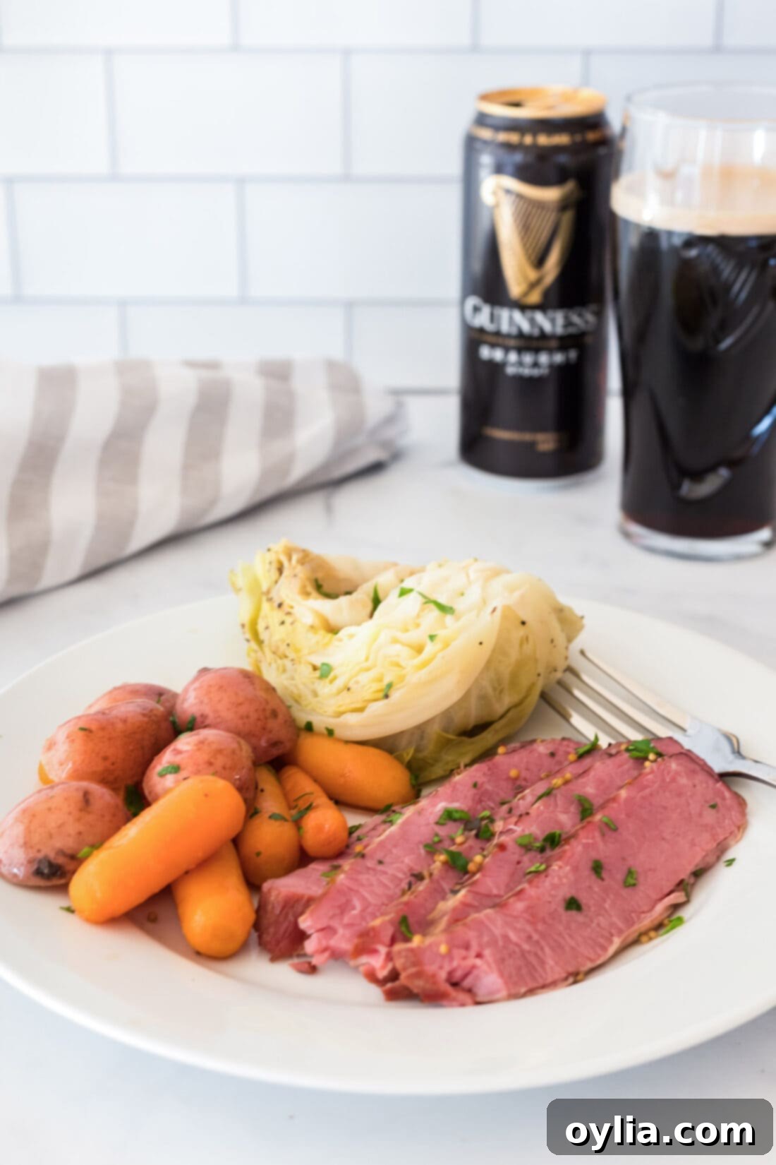 A perfectly plated Instant Pot corned beef dinner, with sliced brisket, tender cabbage, carrots, and potatoes