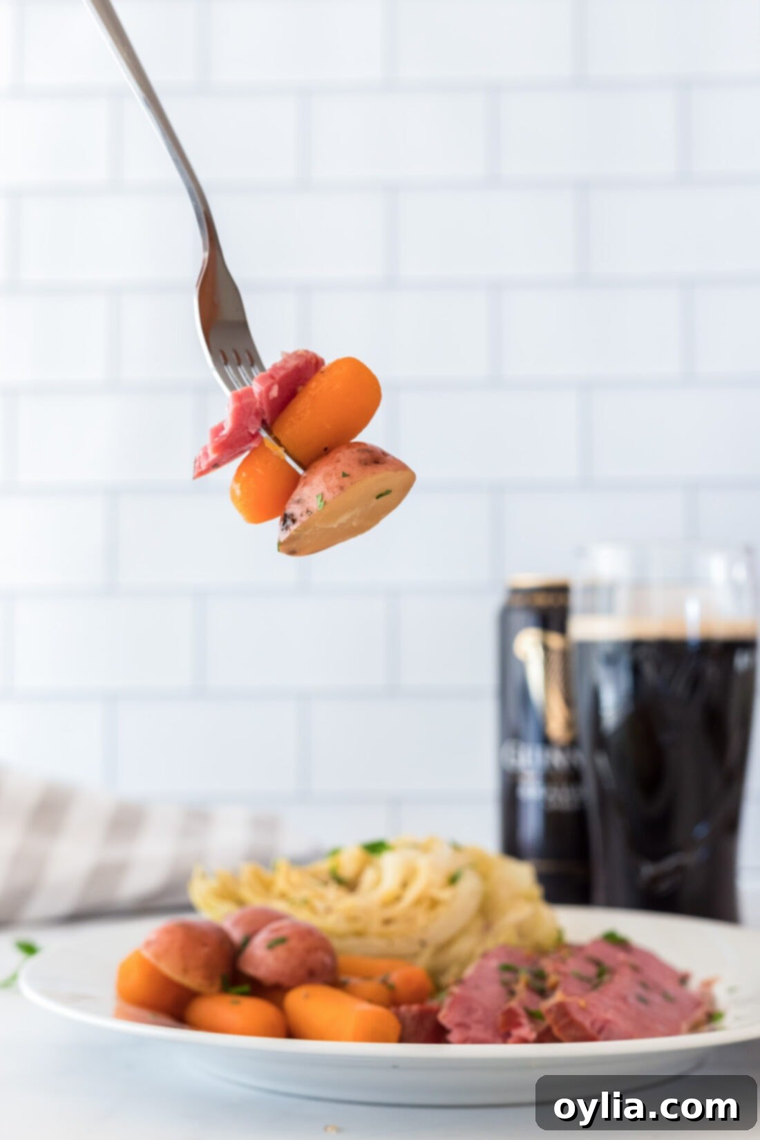 fork with a piece of tender corned beef and colorful veggies, showcasing the perfect cook