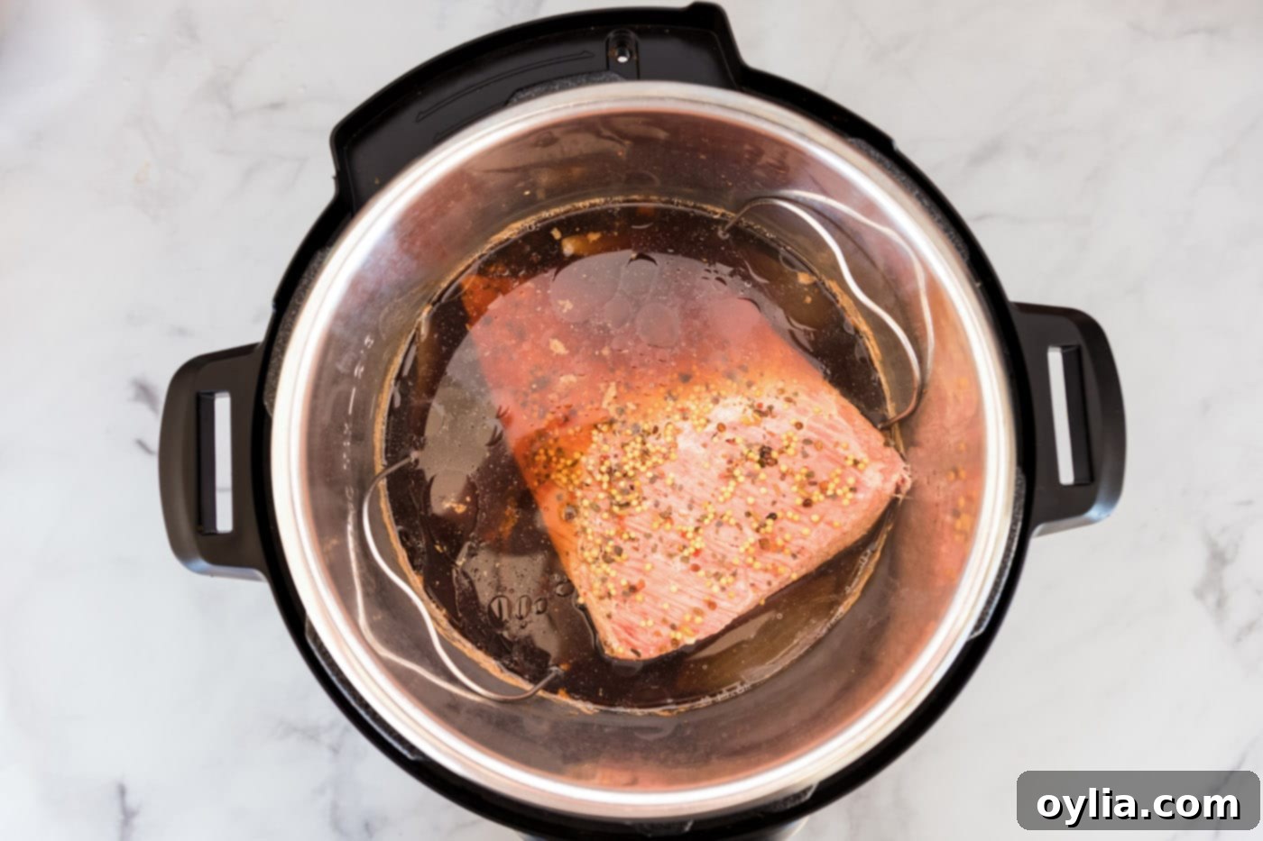 Cooked corned beef in Instant Pot after pressure release, ready to be removed