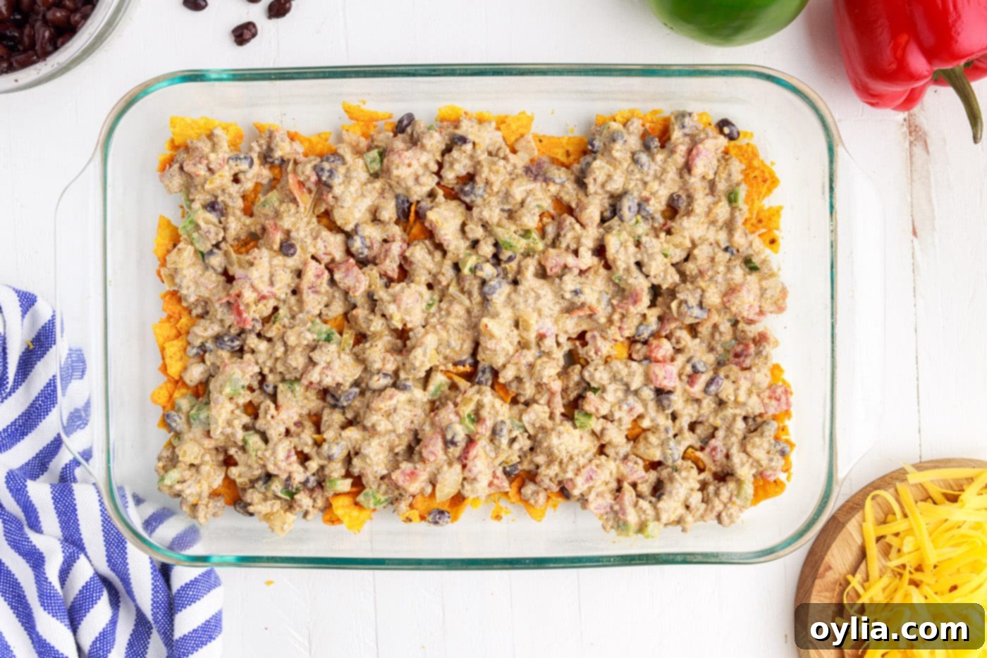 ground beef mixture over crushed doritos
