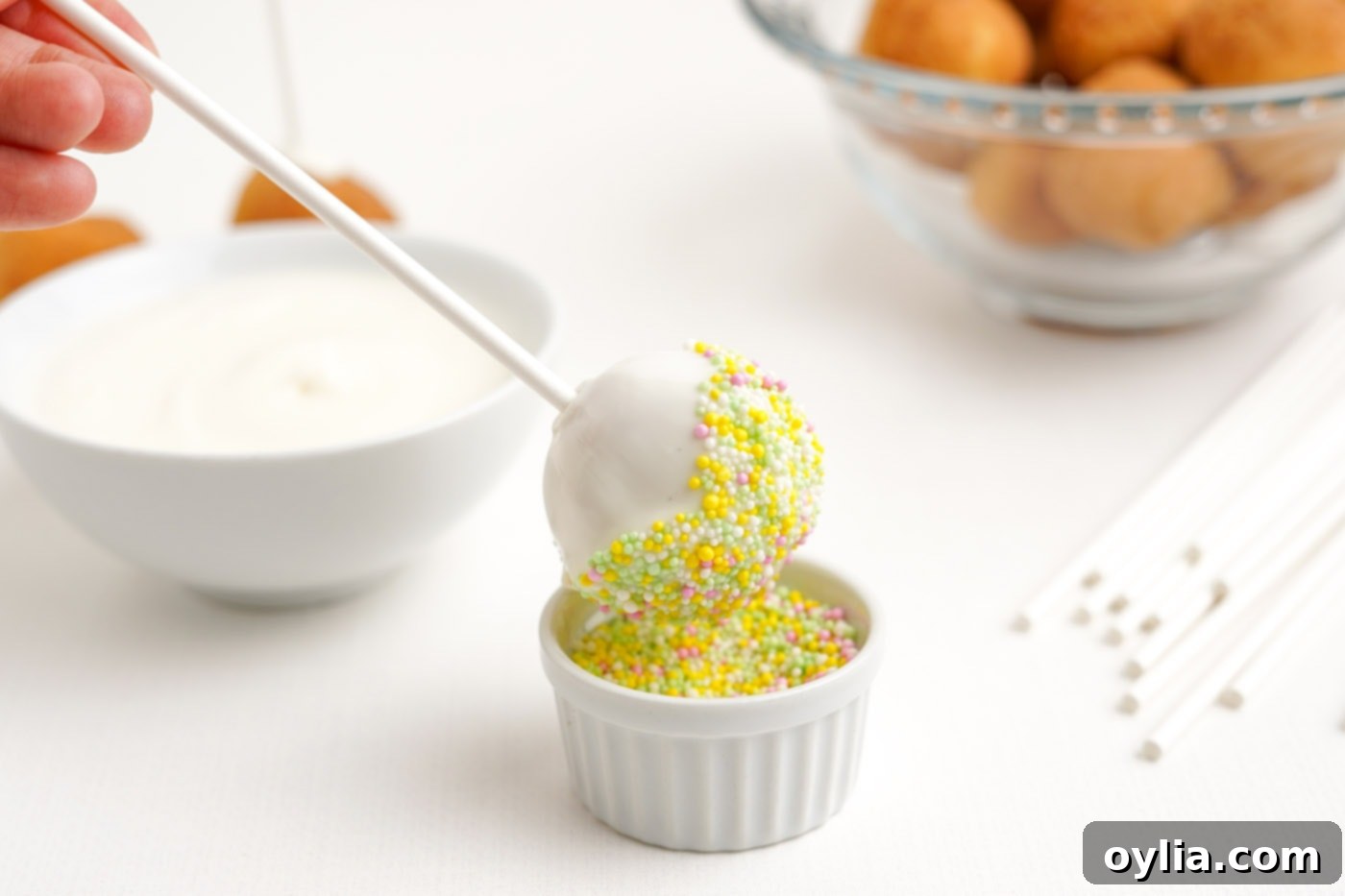 dipping cake pop into sprinkles