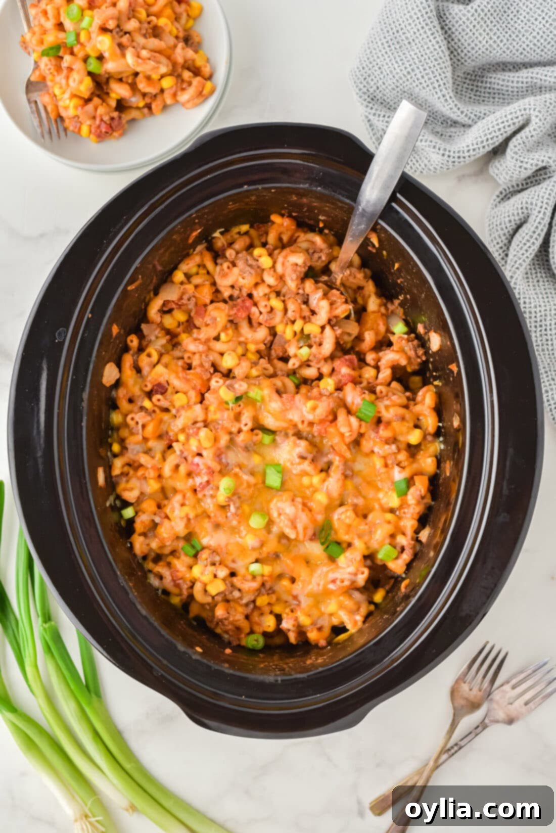 overhead photo of Crockpot Ground Beef Casserole, a comforting mix of pasta, ground beef, and melted cheese