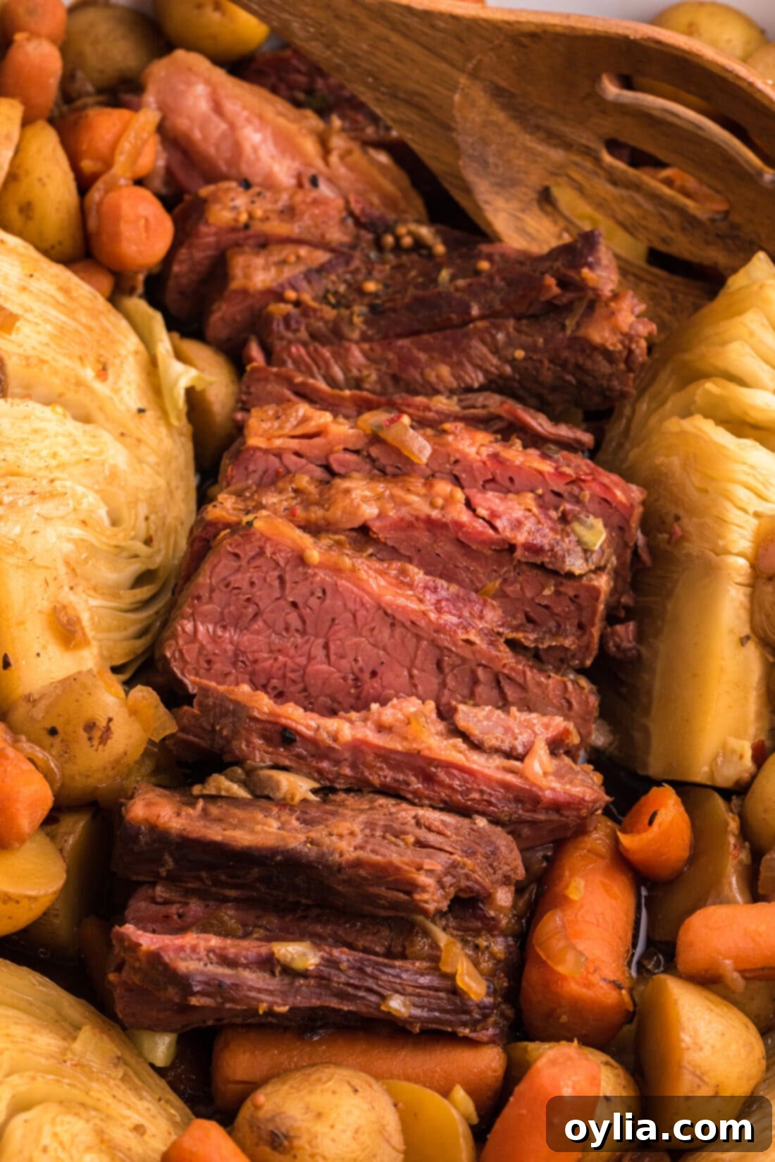 Crockpot Corned Beef with roasted vegetables like baby carrots, potatoes, and cabbage wedges