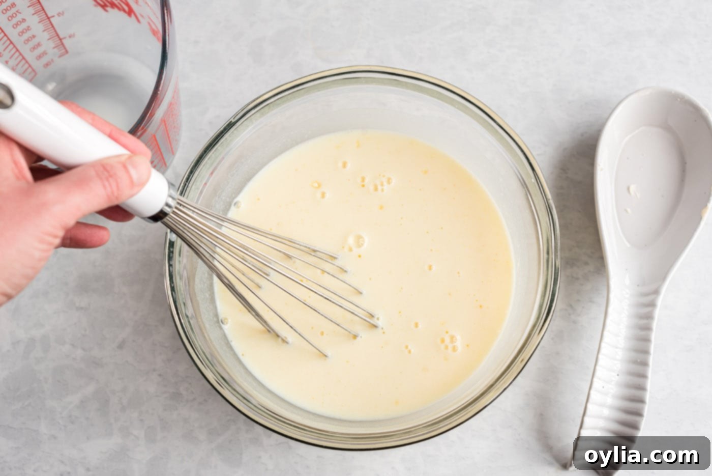 whisking instant vanilla pudding in a bowl