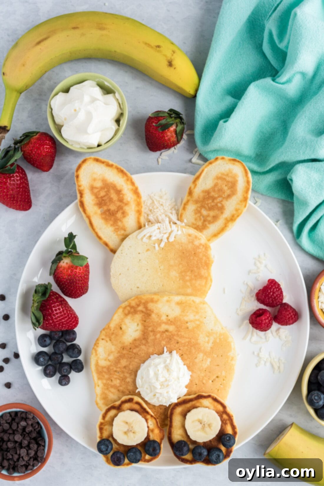 Another view of an assembled Bunny Butt Pancake, highlighting the creative presentation with fruit and whipped cream against a clean white plate, perfect for Easter.
