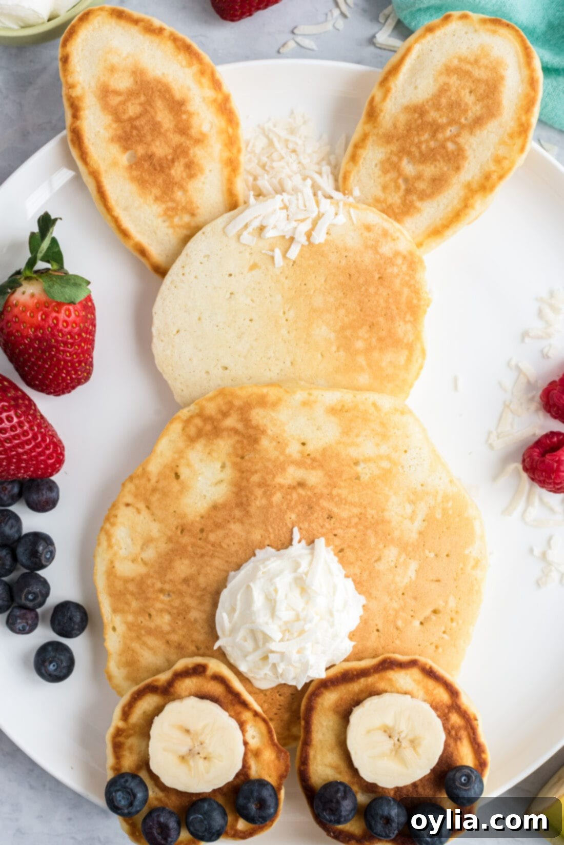 Close up view of decorated Bunny Butt Pancakes, showing the fluffy texture and vibrant fruit toppings, ready for a fun Easter breakfast.