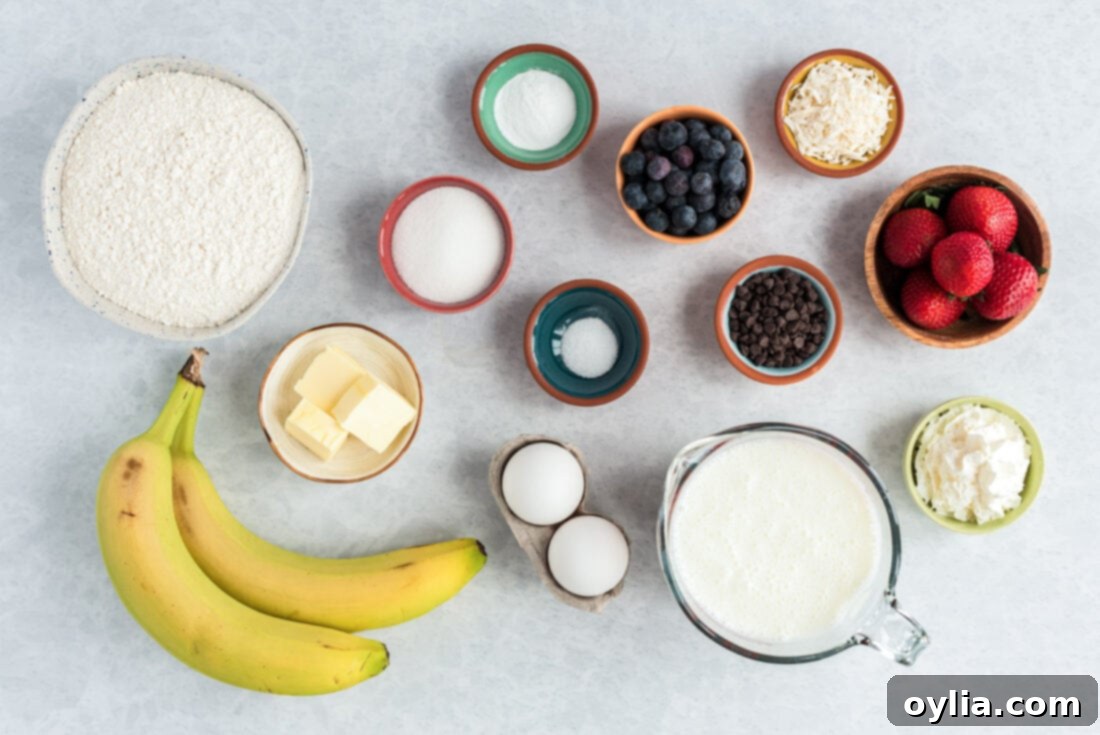 A collection of ingredients laid out for making Bunny Butt Pancakes, including flour, sugar, baking soda, salt, buttermilk, eggs, melted butter, bananas, blueberries, and whipped cream.